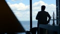 Man silhouette enjoying break in conference room. Manager going at his pause
