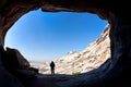 Man silhouette in front of a cave entrance Royalty Free Stock Photo
