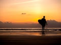 Man silhouette holding surfing board, walking on dark seashore with copy space. Surfer standing on sunset sky over the sea water Royalty Free Stock Photo