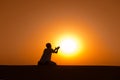 Man silhouette kneel and pray for help Royalty Free Stock Photo