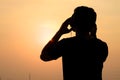 Man silhouette listening to the headphones on the sunset Royalty Free Stock Photo