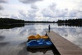 Man silhouette on the pier and cloudy sky with its reflex in the calm water of lake Royalty Free Stock Photo