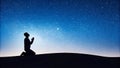 A man in silhouette praying under a starry night sky during Ramadan kareem with copyspace Royalty Free Stock Photo