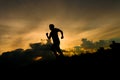 Man silhouette running on sunset