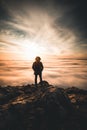 Man silhouette stay on a mountain top watching the sunset Royalty Free Stock Photo