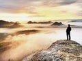 Man silhouette stay on sharp rock peak. Satisfy hiker enjoy view. Tall man on rocky cliff Royalty Free Stock Photo