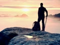 Man silhouette stay on sharp rock peak. Satisfy hiker enjoy view. Tall man on rocky cliff Royalty Free Stock Photo