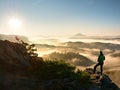 Man silhouette stay on sharp rock peak. Satisfy hiker enjoy view. Royalty Free Stock Photo