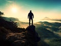 Man silhouette stay on sharp rock peak. Satisfy hiker enjoy view. Royalty Free Stock Photo