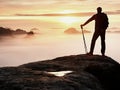 Man silhouette stay on sharp rock peak. Satisfy hiker enjoy view. Tall man on rocky cliff Royalty Free Stock Photo