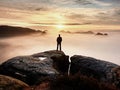 Man silhouette stay on sharp rock peak. Satisfy hiker enjoy view. Tall man on rocky cliff Royalty Free Stock Photo