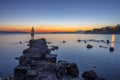 Man silhouette watching the sunset over the Mediterranean Sea from the Aegina island in Saronic gulf, Greece Royalty Free Stock Photo