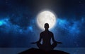 Man silhouette in moonlight, meditation under stars, full moon on night sky Royalty Free Stock Photo