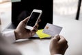 A man with a Silver credit card and a smartphone.