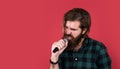 man singer love music. brutal man sing with microphone. vocal school. brutal and rock. bearded man wear checkered shirt Royalty Free Stock Photo