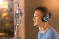 Man singing in front of recording microphone. Royalty Free Stock Photo