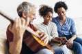 Man singing and playing guitar for his daughter and his wife Royalty Free Stock Photo