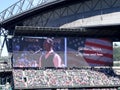 Man sings God Bless America on digital screen