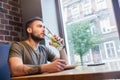 Man sipping cold drink in a restaurant.