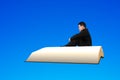 Man sit on book flying in the blue sky Royalty Free Stock Photo