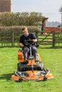 A man on a sit on lawn mower Royalty Free Stock Photo