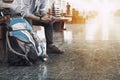 A man sit with map. travel bag at the train station.