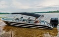 Man sit in motor boat or powerboat moored at sea shore in manaus, brazil. Water transport and vessel. Summer vacation