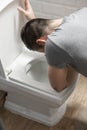 Man sit near the toilet and vomits Royalty Free Stock Photo