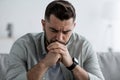 Man sit on sofa and feeling stressed at bad news, depression, loneliness