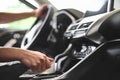 The man sits behind the wheel of a passenger car and pulls the handbrake. Royalty Free Stock Photo