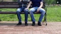 A man sits on a bench to him comes and another man sits down and strokes his leg, homosexuality, harassment