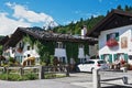 Man sits in front of the traditional bavarian house in Mittenwald, Germany.