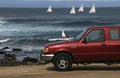 3/29/2020: A man sits in his red truck by the ocean during shelter in place, Pacific Grove, CA.