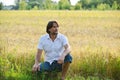 Man sits near a wheat field Royalty Free Stock Photo