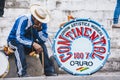 A man sits next to a bass drum during the festival in honour of the Santiago Apostle, Patron Saint of Quime, Bolivia