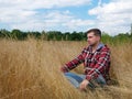 Man sits and rests in the autumn nature. Relaxation and tourism.