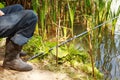 A man sits on the river bank and catches fish. Royalty Free Stock Photo