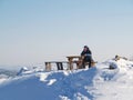 Man sits at a table on top of a mountain