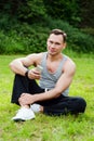 Man sits with a telephone on the grass