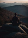 Man Sitting on Top of Large Rock. Generative AI. Royalty Free Stock Photo