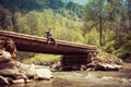 Man sits on a wooden bridge Royalty Free Stock Photo