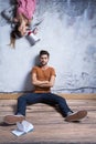 Man sitting against wall