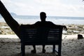 Man Sitting alone on a bench near Seashore
