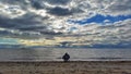 Man sitting alone facing sea Royalty Free Stock Photo