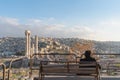A man sitting alone listening music by headphone at Citadel in Amman, Jordan