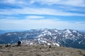Man sitting alone, looking at the beautiful mountain snowy peaks during sunny day, Carpathian mountains, Ukraine Royalty Free Stock Photo