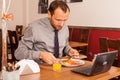 Man sitting alone in restaurant with laptop Royalty Free Stock Photo