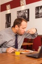 Man sitting alone in restaurant with laptop Royalty Free Stock Photo