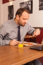 Man sitting alone in restaurant with laptop Royalty Free Stock Photo