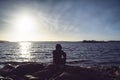 Man sitting alone by the sea. Royalty Free Stock Photo